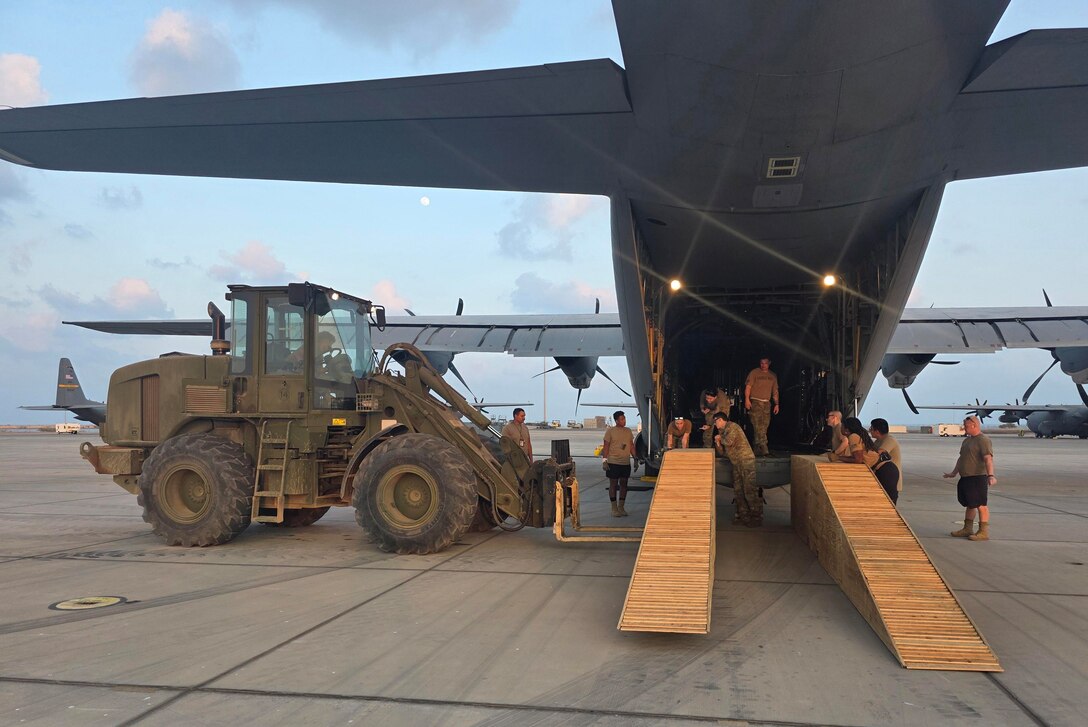 Virginia National Guard Soldiers assigned to the Powhatan-based 180th Engineer Support Company, 276th Engineer Battalion, 329th Regional Support Group load a Caterpillar D6K Dozer onto a West Virginia Air National Guard C-130J Super Hercules