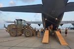 Virginia National Guard Soldiers assigned to the Powhatan-based 180th Engineer Support Company, 276th Engineer Battalion, 329th Regional Support Group load a Caterpillar D6K Dozer onto a West Virginia Air National Guard C-130J Super Hercules
