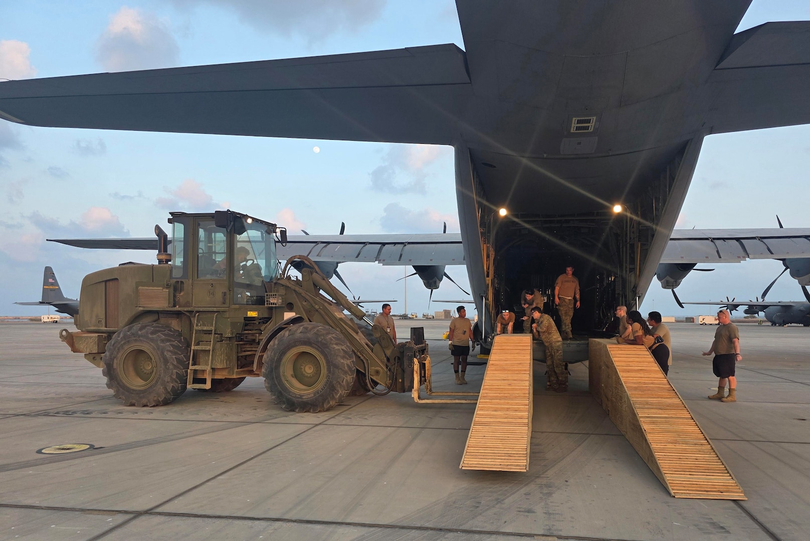 Virginia National Guard Soldiers assigned to the Powhatan-based 180th Engineer Support Company, 276th Engineer Battalion, 329th Regional Support Group load a Caterpillar D6K Dozer onto a West Virginia Air National Guard C-130J Super Hercules