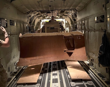Virginia National Guard Soldiers assigned to the Powhatan-based 180th Engineer Support Company, 276th Engineer Battalion, 329th Regional Support Group load a Caterpillar D6K Dozer onto a West Virginia Air National Guard C-130J Super Hercules