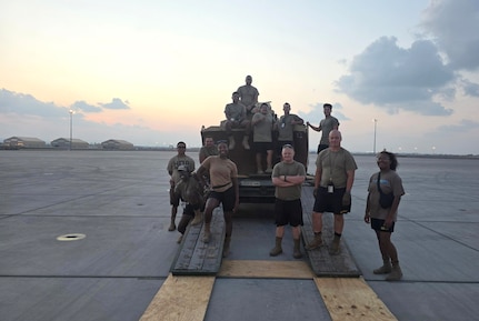 Virginia National Guard Soldiers assigned to the Powhatan-based 180th Engineer Support Company, 276th Engineer Battalion, 329th Regional Support Group load a Caterpillar D6K Dozer onto a West Virginia Air National Guard C-130J Super Hercules
