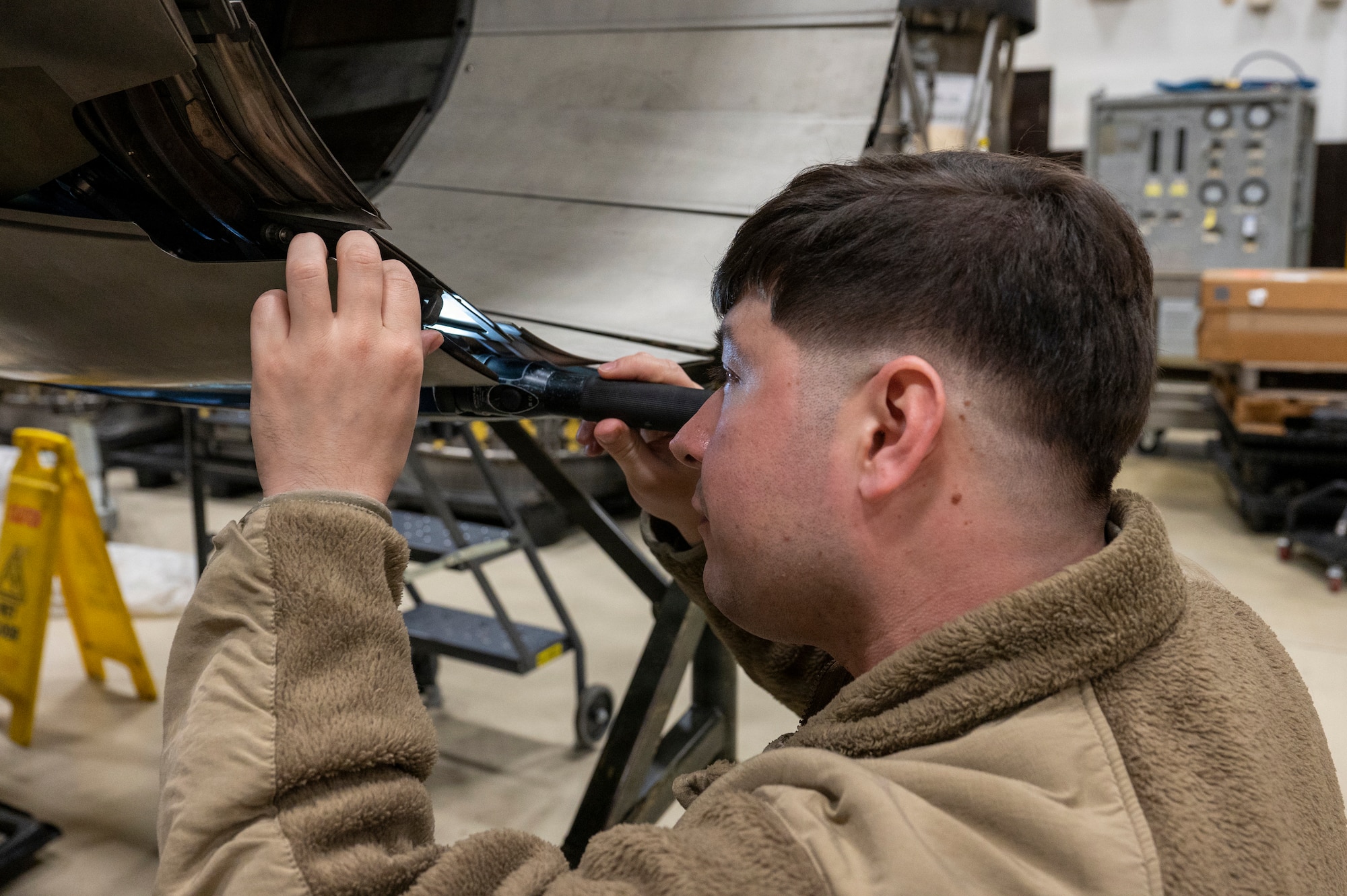 U.S. Air Force Staff Sergeant Michael Ceja, 35th Maintenance Group Quality Assurance, inspects an engine at Misawa Air Base, Japan, Dec. 28, 2025.