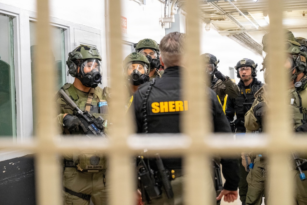SWAT officers stand for a briefing