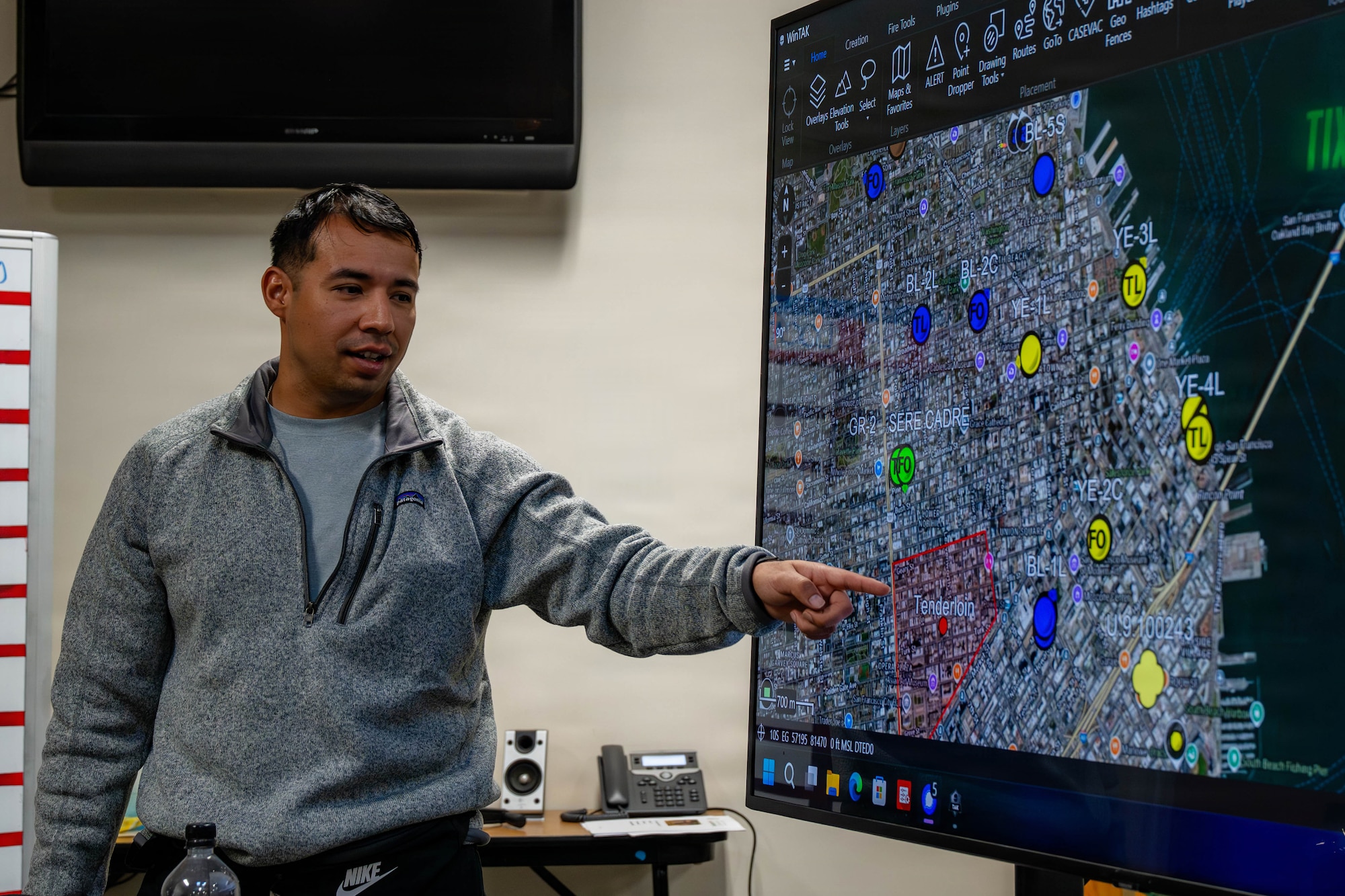 U.S. Air Force Tech. Sgt. points at map on a screen