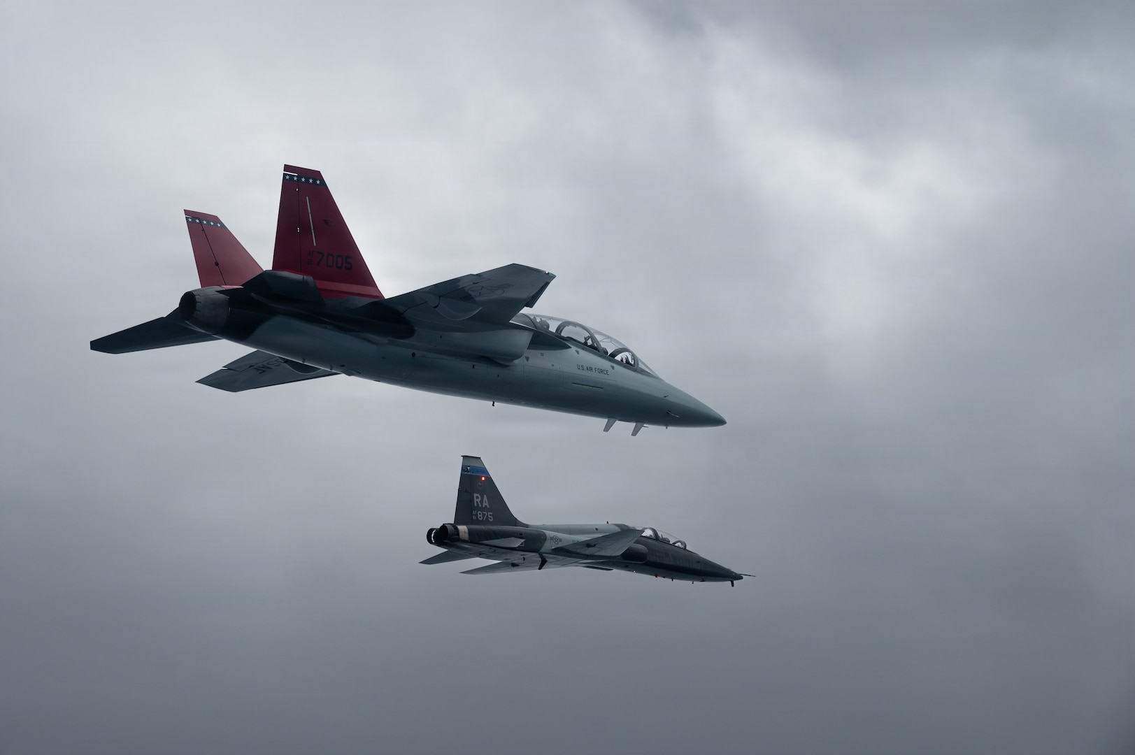 A U.S. Air Force T-38 from the 560th Flying Training Squadron flies alongside a T-7A Red Hawk during the aircraft’s historic arrival to Air Education and Training Command at Joint Base San Antonio-Randolph, Texas, Dec. 3, 2025.