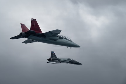A U.S. Air Force T-38 from the 560th Flying Training Squadron flies alongside a T-7A Red Hawk during the aircraft’s historic arrival to Air Education and Training Command at Joint Base San Antonio-Randolph, Texas, Dec. 3, 2025.
