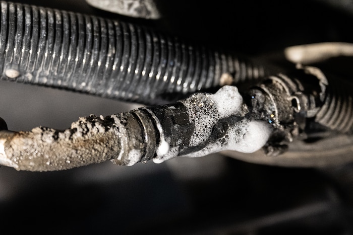 Soapy bubbles foaming around a component.