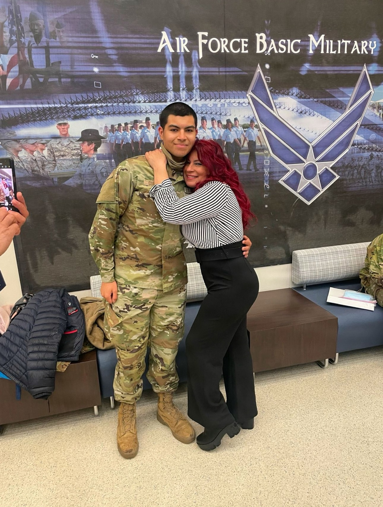 Photo of an Air Force Airman with his mother during basic military training.