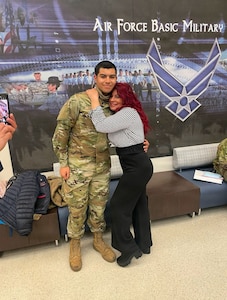 Photo of an Air Force Airman with his mother during basic military training.