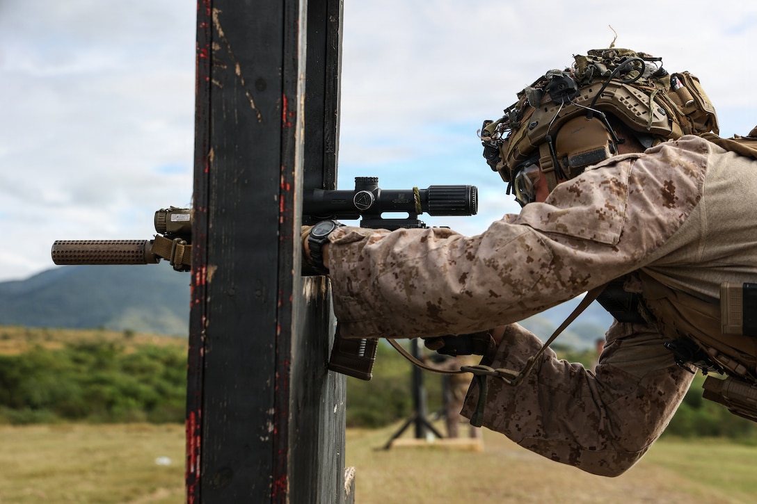 A U.S. Marine with Kilo Company, Battalion Landing Team 3/6, 22nd Marine Expeditionary Unit (Special Operations Capable), sights in on a target with their M27 infantry automatic rifle during a long bay range on Camp Santiago, Puerto Rico, Dec. 9, 2025. U.S. military forces are deployed to the Caribbean in support of the U.S. Southern Command mission, Department of War-directed operations, and the president’s priorities to disrupt illicit drug trafficking and protect the homeland. (U.S. Marine Corps photo)