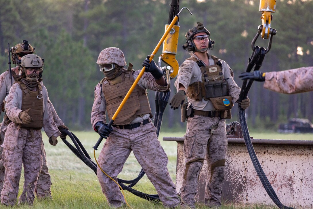 U.S. Marines with Logistics Operations School execute helicopter support team training at Camp Lejeune, North Carolina, July 23, 2025. The HST training is designed to prepare Marines to manage activities at landing zones and to facilitate the pickup, movement, and landing of helicopter-borne troops, equipment, and supplies.