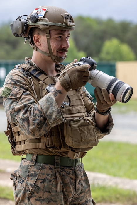 U.S. Marine Corps Lance Cpl. Paul Kalogeris, a combat videographer with Marine Corps Combat Service Support Schools, and a native of Missouri, photographs Marines with Methods of Entry School during a training event at Marine Corps Base Quantico, Virginia