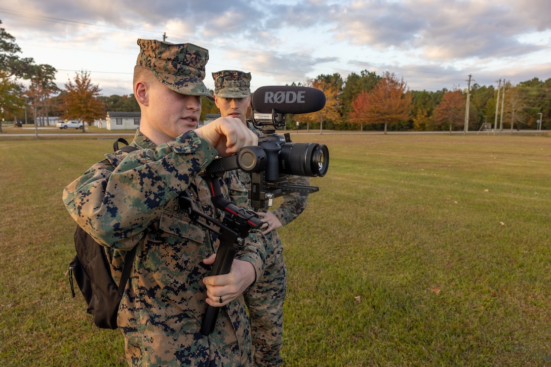 U.S. Marine Corps Lance Cpl. Brant Cushman, a combat videographer with Marine Corps Combat Service Support Schools, and a native of Beaufort, South Carolina, documents Marines prior to a formation run on Camp Gilbert H. Johnson, North Carolina