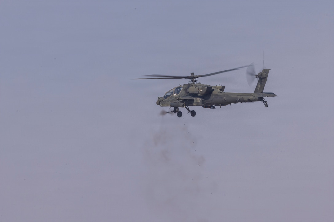 A U.S. Army AH-64D Apache attack helicopter assigned to Task Force Shikra (3-4 AHB), 4th Combat Aviation Brigade fires 30mm rounds at static targets during exercise Sky Shield at the Udari Range Complex, Kuwait, Dec. 5, 2025. Led by Kuwait, exercise Sky Shield is a counter-drone live fire exercise that included participation from the United States, Bahrain, and the United Kingdom. (U.S. Army Photo by Joe Kumzak)