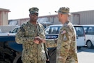 U.S. Navy Fleet Master Chief Lateef Compton, U.S. Central Command senior enlisted leader, shakes hands with a Guardian in the CENTCOM area of responsibility, Jan. 7, 2025. Compton visited multiple sites around the base and had lunch with Airmen and Guardians assigned to U.S. Space Forces - Central. (U.S. Air Force photo by Senior Airman Devlin Bishop)