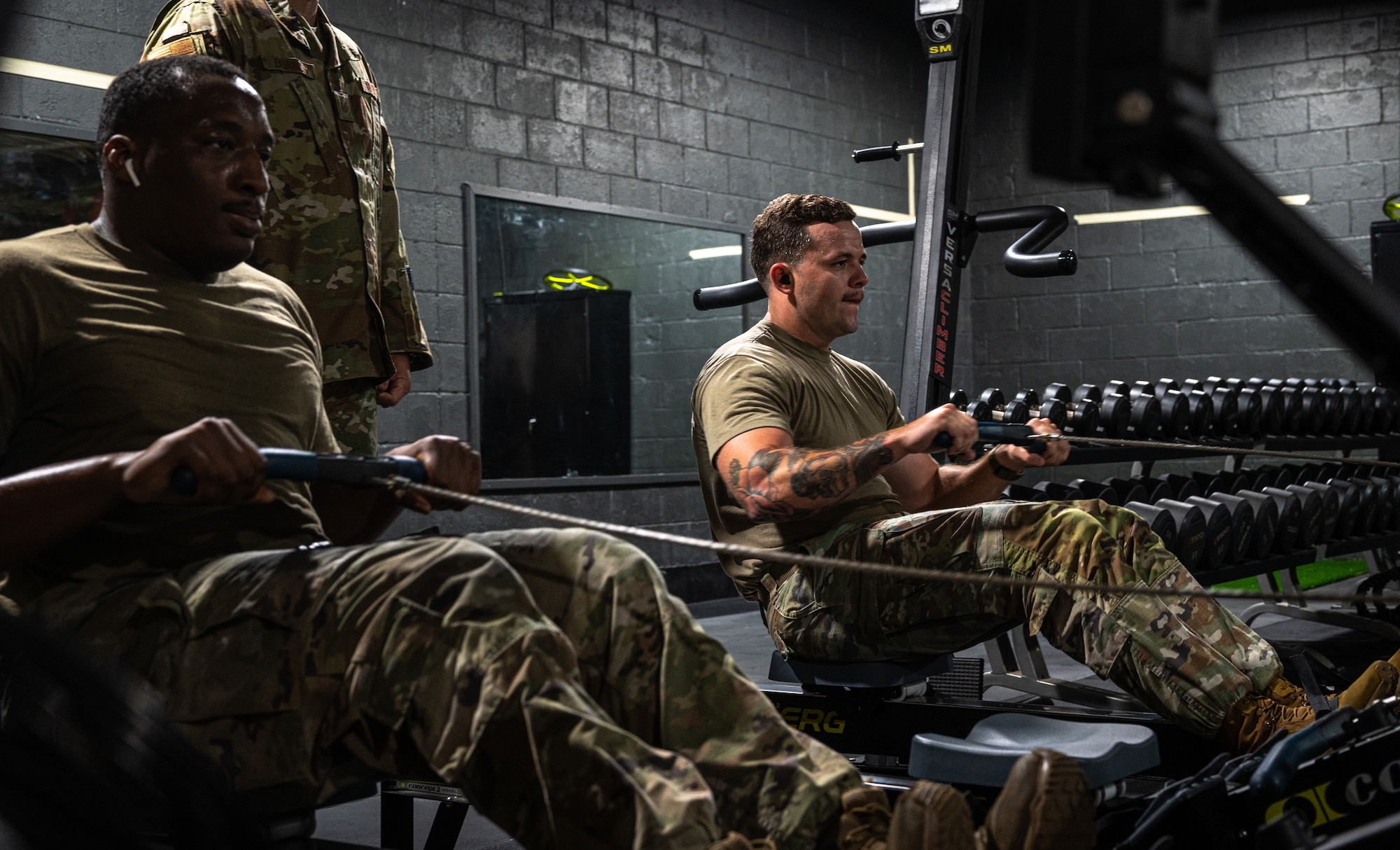 U.S. Air Force Tech. Sgt. Benjamin York (right) and Staff Sgt. Tymalik Garrison, 335th Fighter Generation Squadron maintainers, perform the row machine portion of an Armament Fitness Assessment (AFA) at Seymour Johnson Air Force Base, North Carolina, Oct. 8, 2025. Airman Fitness plays a vital role in the Air Force’s mission by reinforcing mission readiness, discipline and resilience. (U.S. Air Force photo by Airman Holly Leonard)