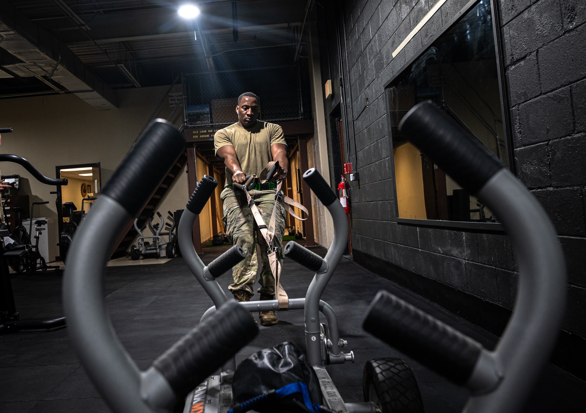 U.S. Air Force Staff Sgt. Tymalik Garrison, 335th Fighter Generation Squadron weapons quality assurance inspector, performs the weighted sled pull portion of an Armament Fitness Assessment (AFA) at Seymour Johnson Air Force Base, North Carolina, Oct. 8, 2025. Airman Fitness plays a vital role in the Air Force’s mission by reinforcing mission readiness, discipline and resilience. (U.S. Air Force photo by Airman Holly Leonard)