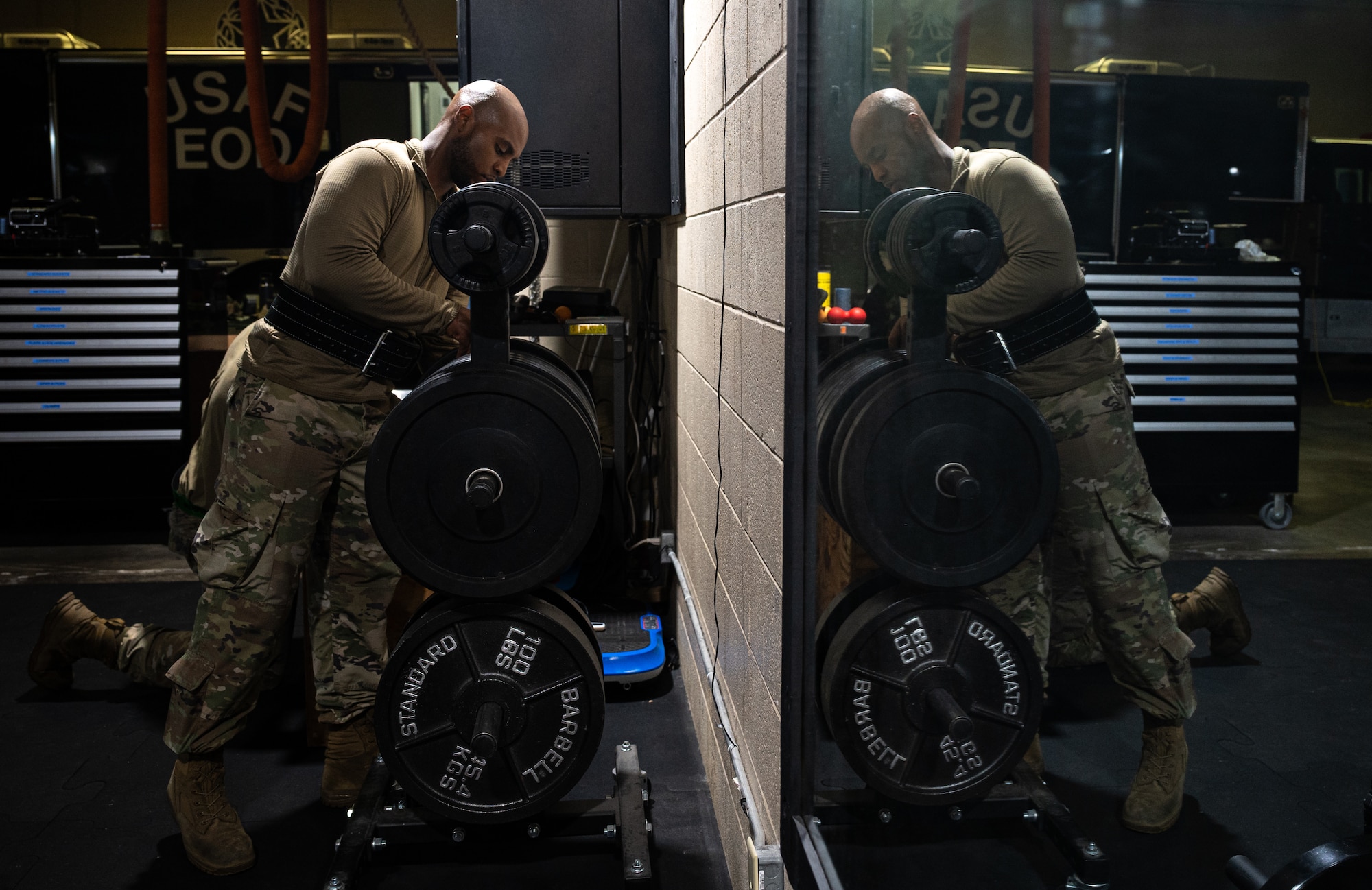 U.S. Air Force Staff Sgt. Karlton Bonty, 4th Munitions Squadron precision-guided munitions crew chief, grabs a weight during an Armament Fitness Assessment (AFA) at Seymour Johnson Air Force Base, North Carolina, Oct. 8, 2025. When maintaining F-15E Strike Eagles, airmen must be in peak physical condition to meet the demands of combat operations. (U.S. Air Force photo by Airman Holly Leonard)