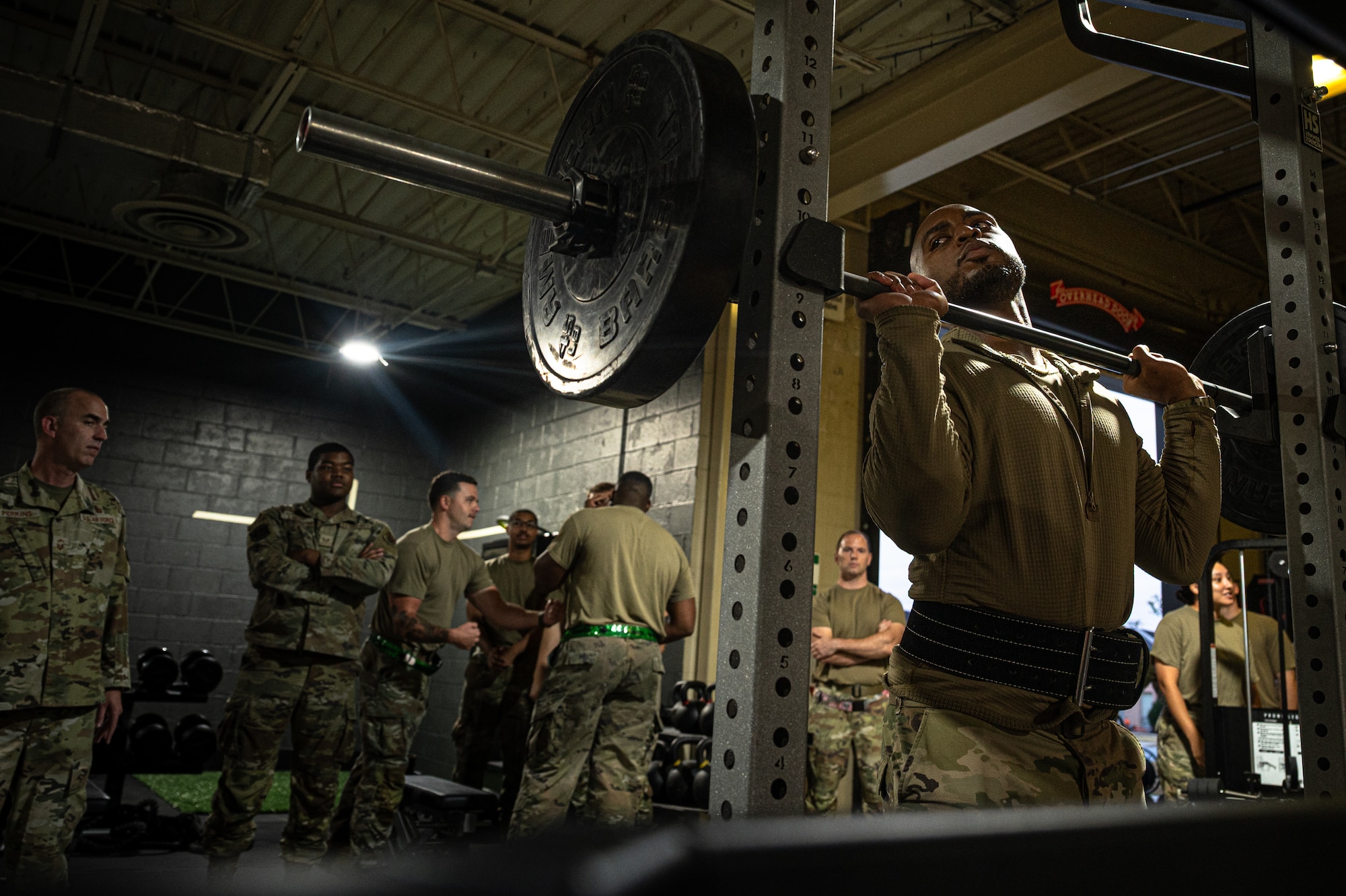 U.S. Air Force Staff Sgt. Karlton Bonty, 4th Munitions Squadron precision-guided munitions crew chief, performs the overhead press portion of an Armament Fitness Assessment (AFA) at Seymour Johnson Air Force Base, North Carolina, Oct. 8, 2025. When maintaining F-15E Strike Eagles, airmen must be in peak physical condition to meet the demands of combat operations. (U.S. Air Force photo by Airman Holly Leonard)