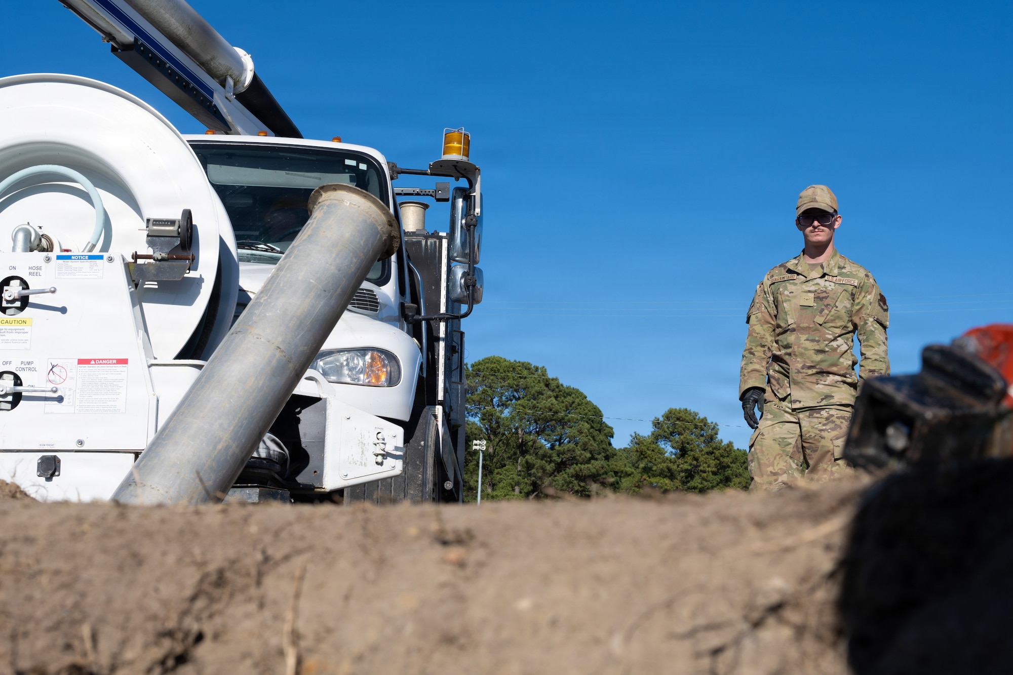 U.S. Air Force Airman Peter Sharamitaro, 4th Civil Engineer Squadron water and fuel systems maintenance apprentice, stands next to a hydro excavator at Seymour Johnson Air Force Base, North Carolina, Nov. 17, 2025. The water and fuels systems maintenance shop is responsible for managing the plumbing, wastewater collection systems, liquid fuel storage and natural gas distribution systems on every base. (U.S. Air Force photo by Airman Daryl Briscoe)