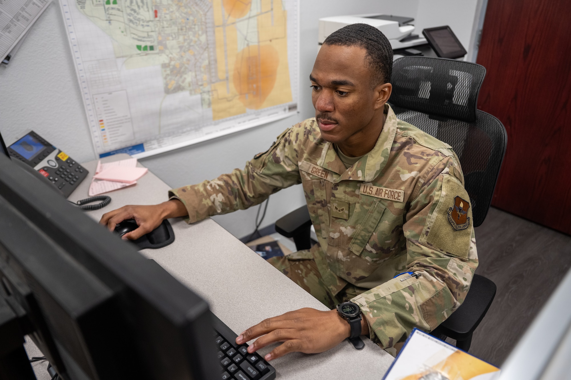 U.S. Air Force Airman 1st Class Detravion Green, 97th Security Forces Squadron (SFS) logistics supply technician, works at his desk inside of the 97th SFS building at Altus Air Force Base, Oklahoma, Dec. 15, 2025. Green was recognized for his consistency, professionalism and positive impact he brings to his team and the mission. (U.S. Air Force photo by Airman 1st Class Nathan Langston)