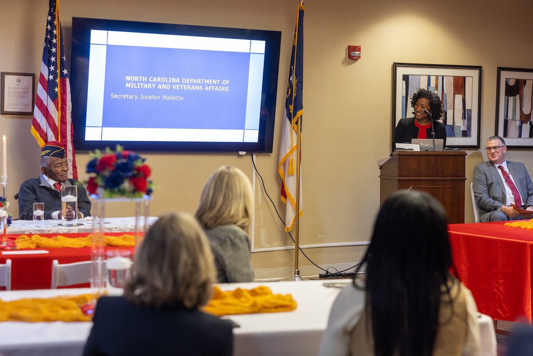 Secretary Jocelyn M. Mallette, right, North Carolina Department of Military and Veterans Affairs, shares her remarks and birthday wishes during Oliver Diggs' 100th birthday celebration in Kinston, North Carolina, Jan. 5, 2026. Diggs, a Montford Point Marine veteran served from April 4, 1944 to June 22, 1946, as a part of the group of African American Marines who broke barriers and paved the way for future generations. His service and centennial birthday were celebrated by his family and distinguished guests at the North Carolina State Veterans Home. (U.S. Marine Corps photo by Lance Cpl. Alyssa J. DeCrane)
