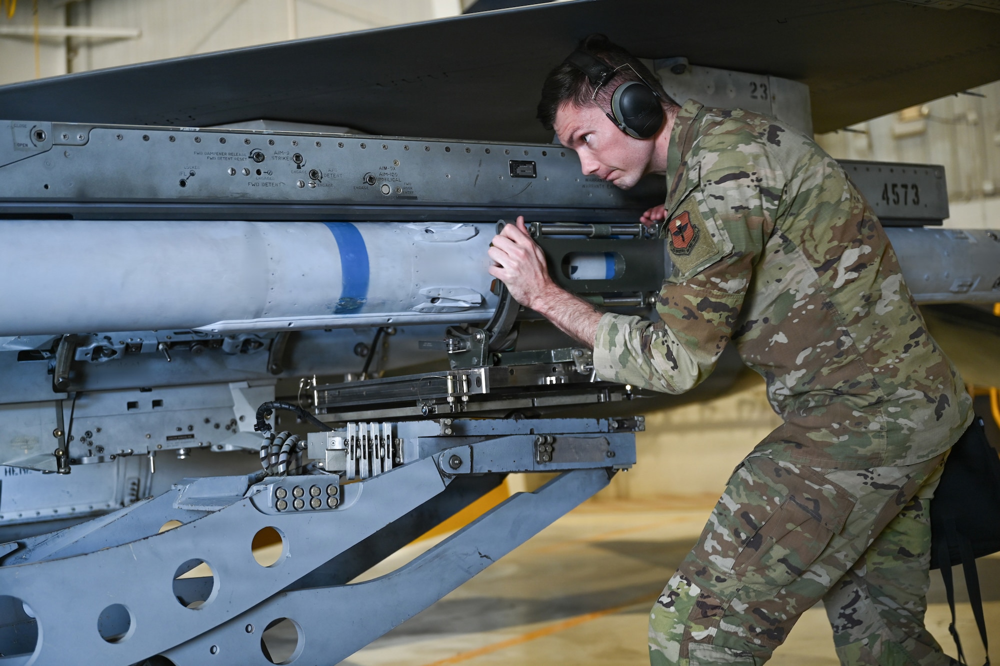 U.S. Air Force Staff Sgt. Kenneth Sherman, 849th Aircraft Maintenance Squadron lead crew member, securely moves an AIM-120 missile onto an F-16 Fighting Falcon during a monthly load training at Holloman Air Force Base, New Mexico, Dec. 19, 2025. 