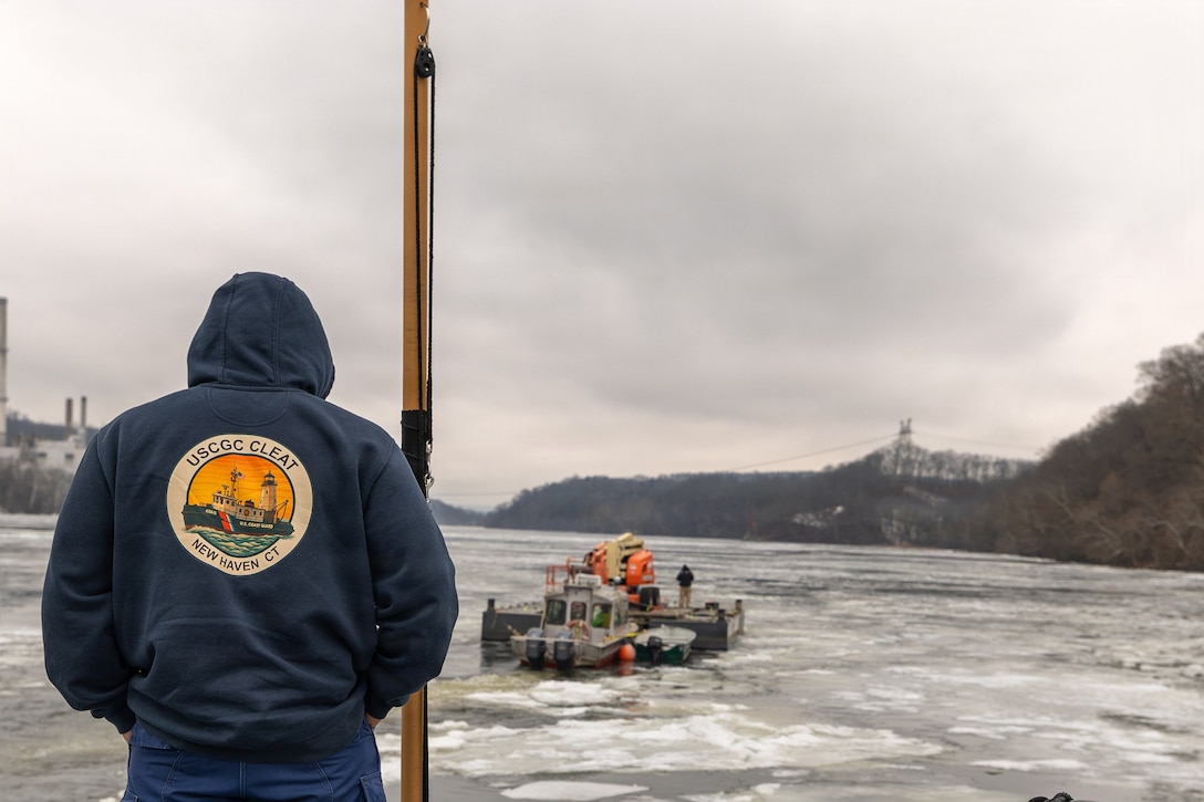 Coast Guard Cutter Cleat escorts a tug through semi-frozen waters