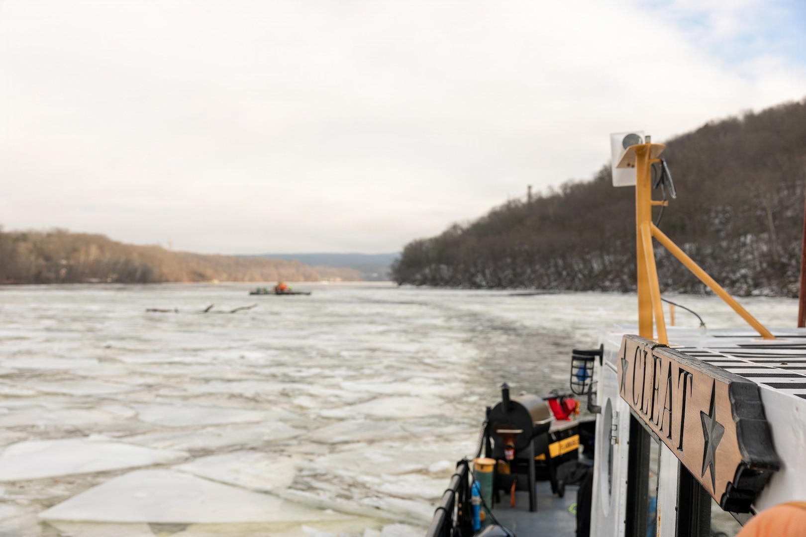 Coast Guard Cutter Cleat escorts a tug through semi-frozen waters