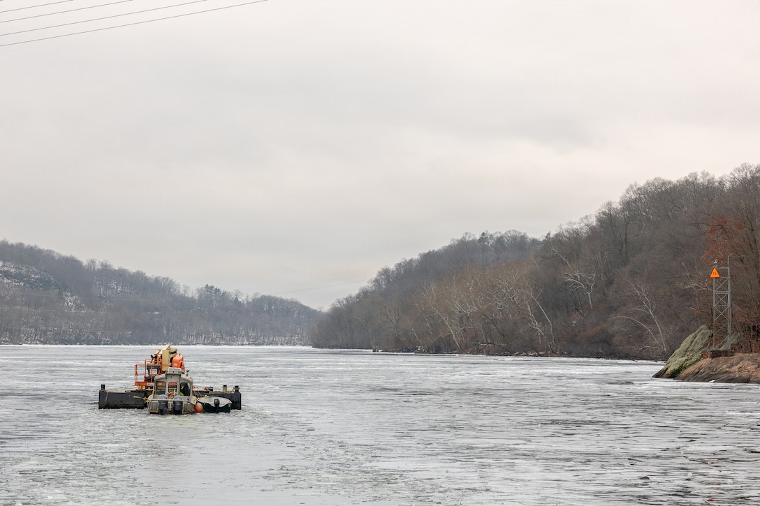 Coast Guard Cutter Cleat escorts a tug through semi-frozen waters