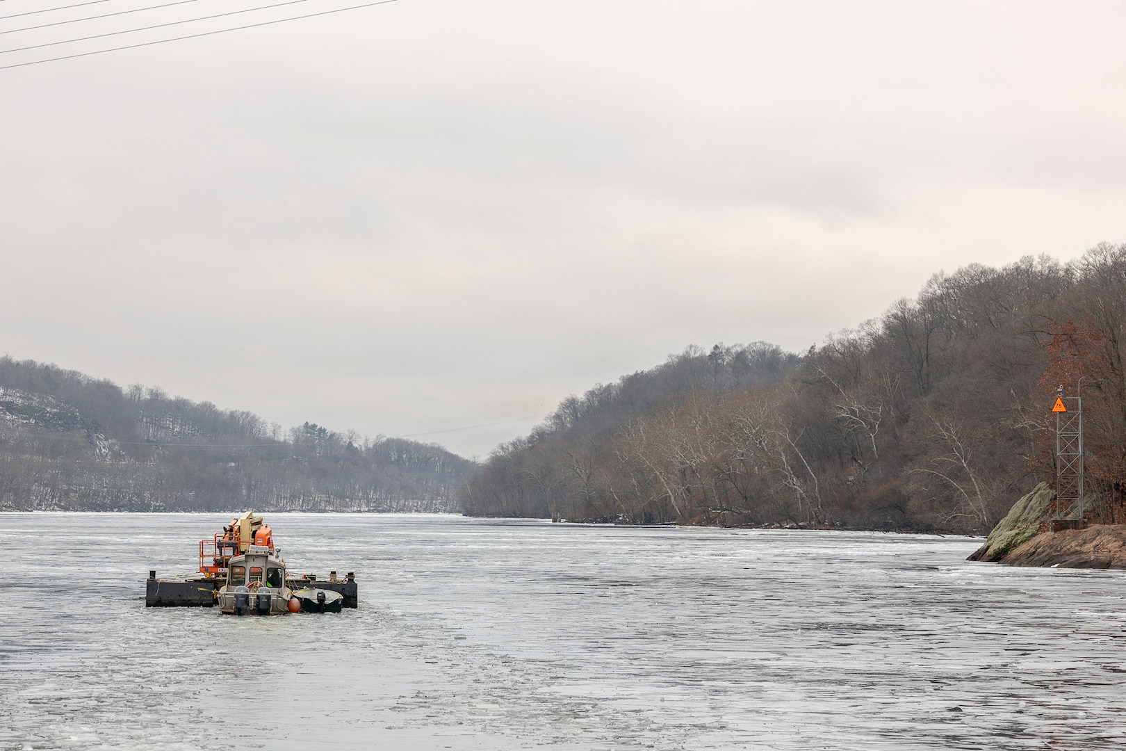 Coast Guard Cutter Cleat escorts a tug through semi-frozen waters