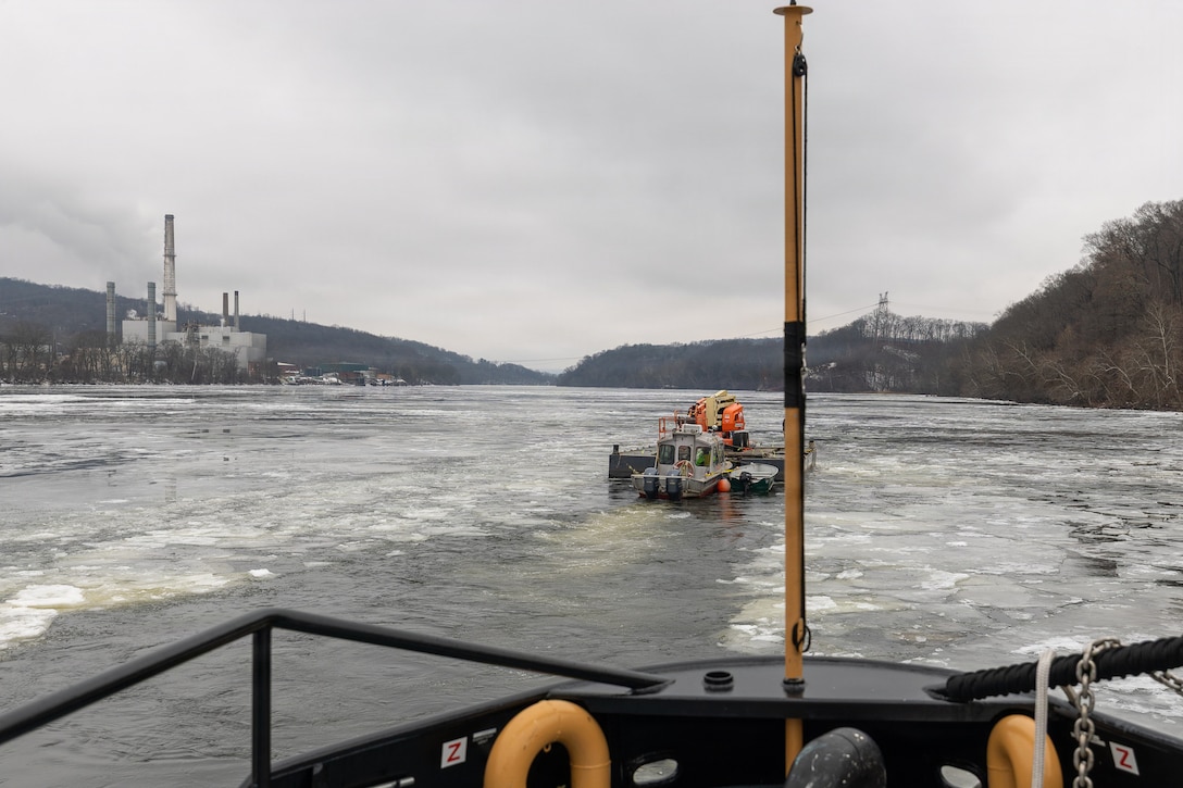 Coast Guard Cutter Cleat escorts a tug through semi-frozen waters