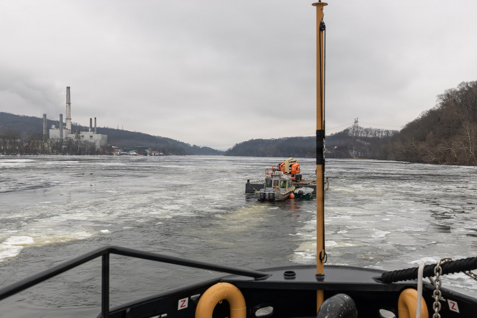 Coast Guard Cutter Cleat escorts a tug through semi-frozen waters