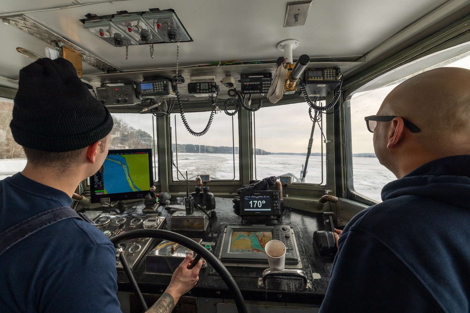 Coast Guard Cutter Cleat escorts a tug through semi-frozen waters