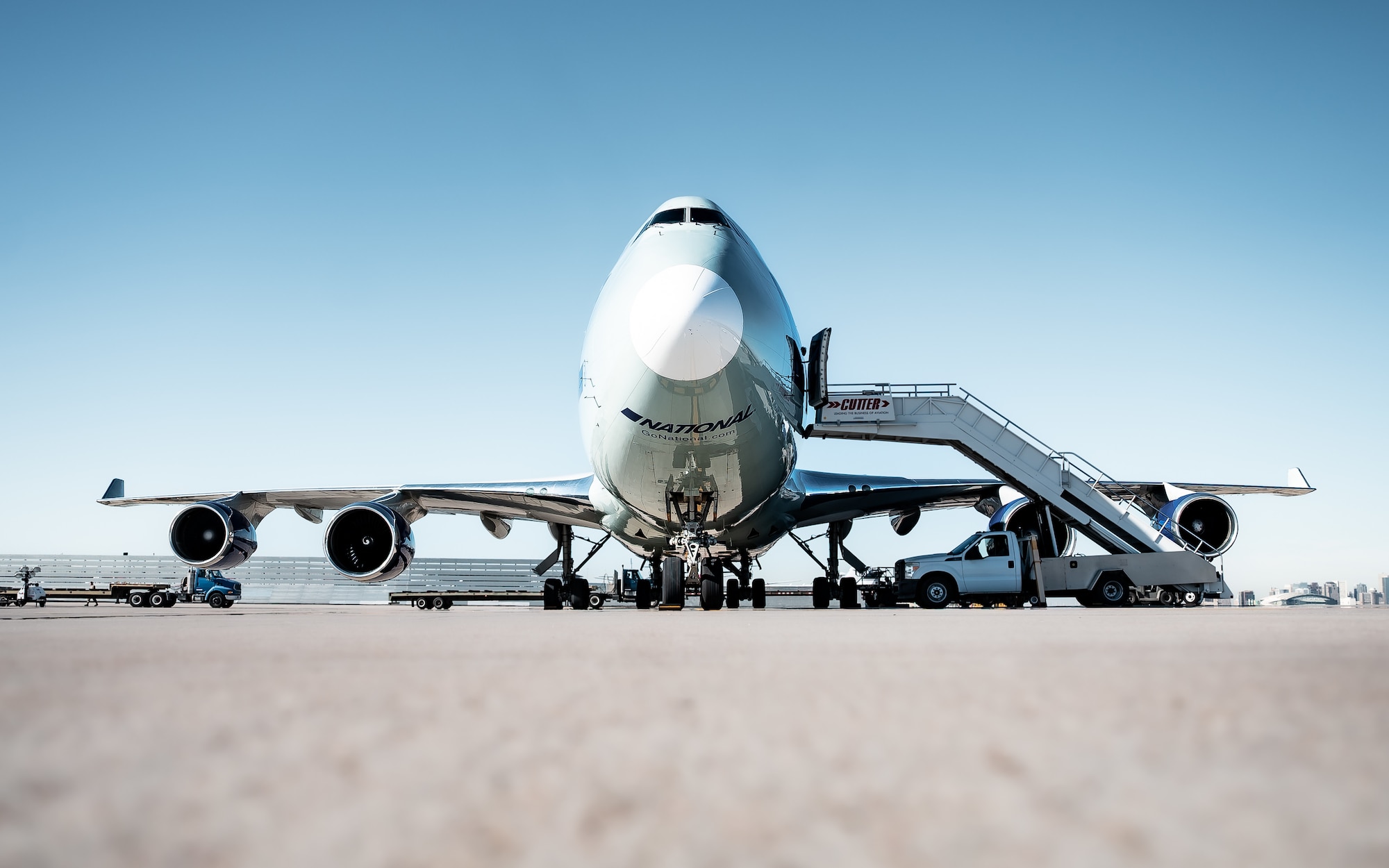 U.S. Air Force Airmen assigned to the 56th Fighter Wing and the 161st Logistics Readiness Squadron operate K-Loaders and tractor trailers to transport munitions cargo from a Boeing 747 during a Special Assignment Airlift Mission