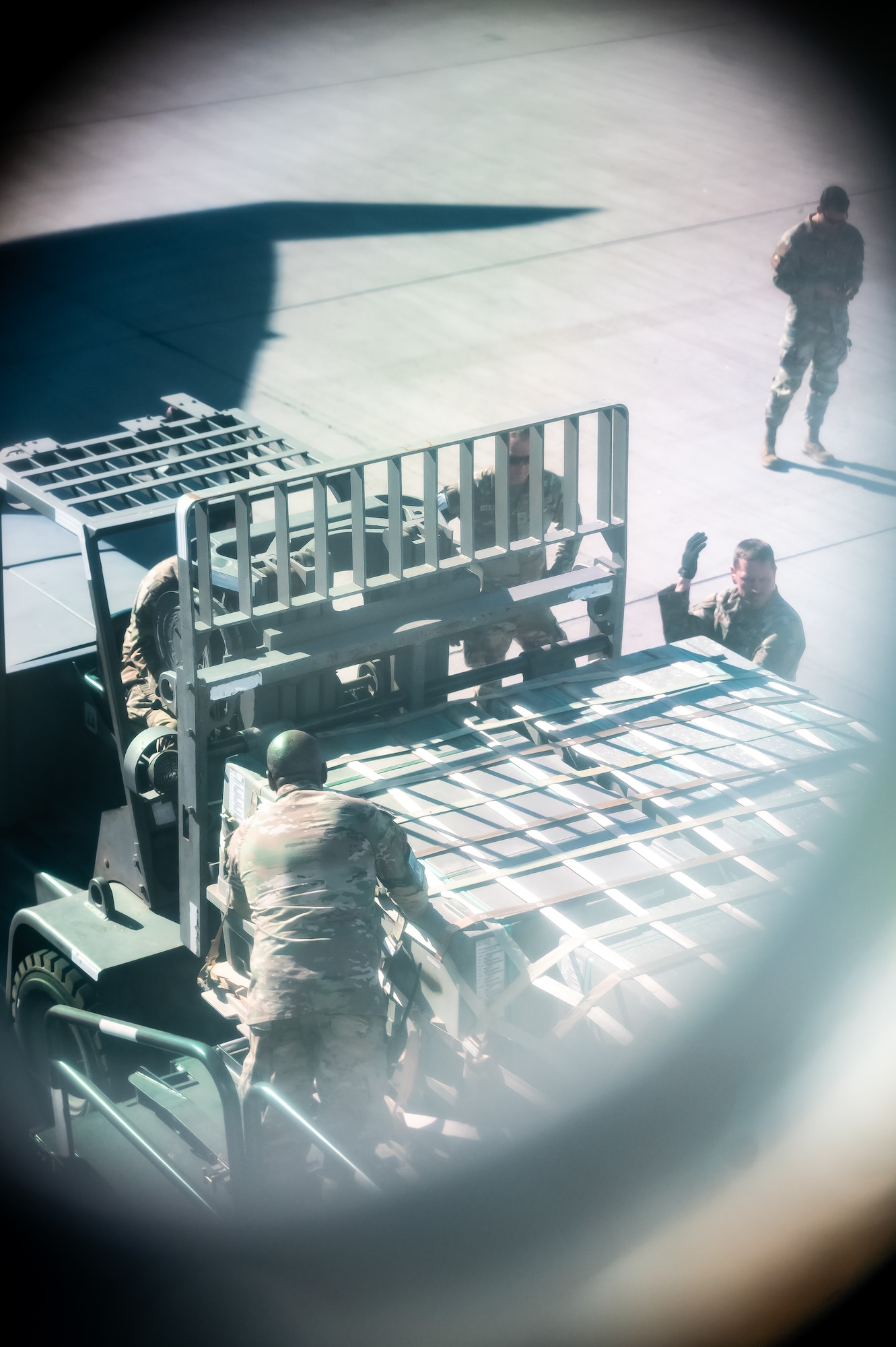U.S. Air Force Airmen assigned to the 56th Fighter Wing coordinate the transfer of cargo pallets