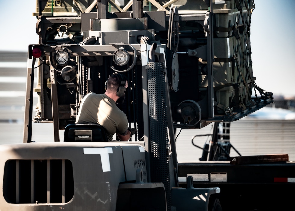 U.S. Air Force Tech. Sgt Corey Klucker, 56th Logistics Readiness Squadron air terminal function non-commissioned officer in-charge, operates a 10K forklift with cargo pallet of munitions tail kits during Special Assignment Airlift Mission