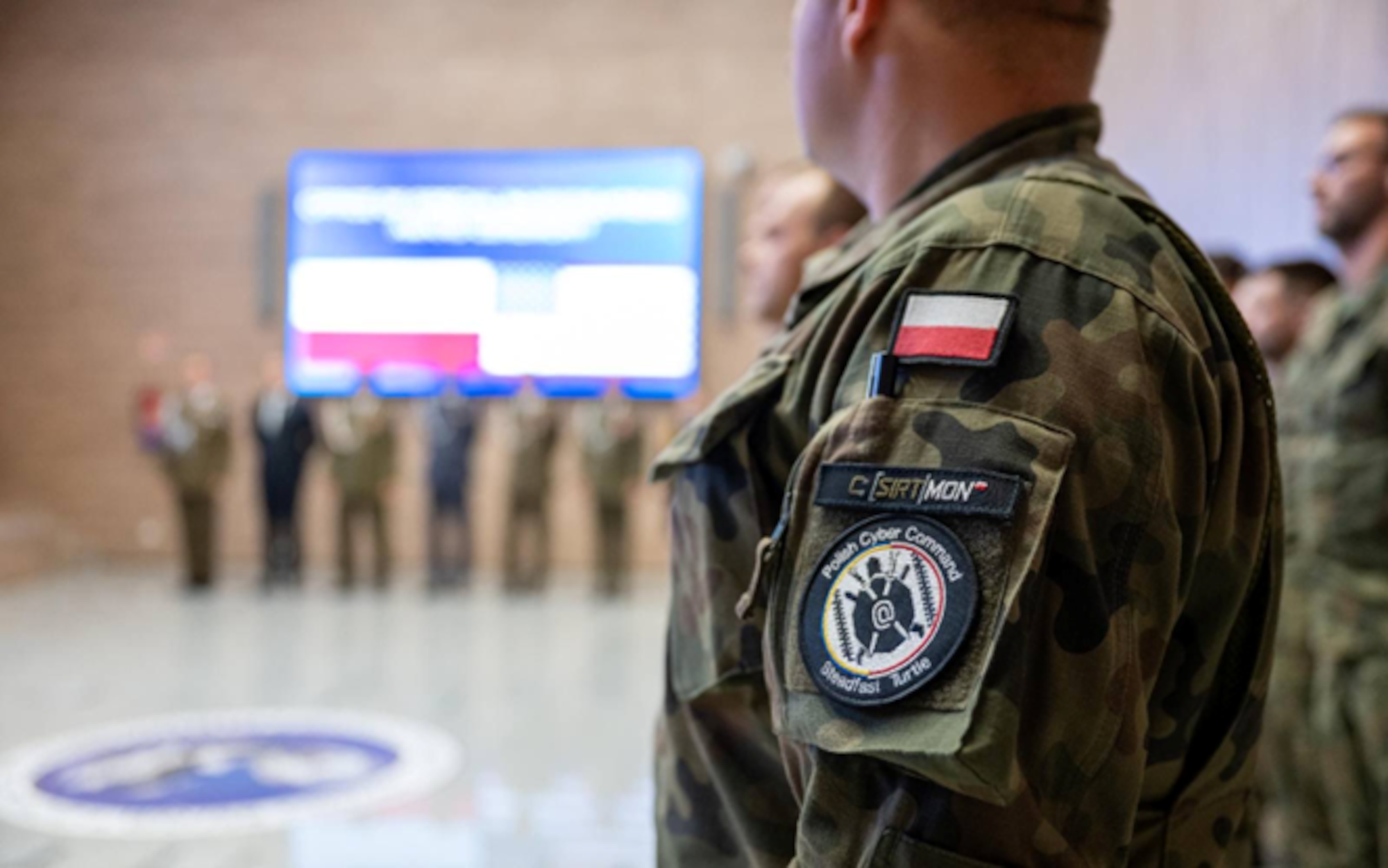 A Polish Cyberspace Defense Forces soldier stands in formation during a ceremony in Warsaw, where Brig. Gen. Amy Bumgarner, commander of the Air Force Office of Special Investigation