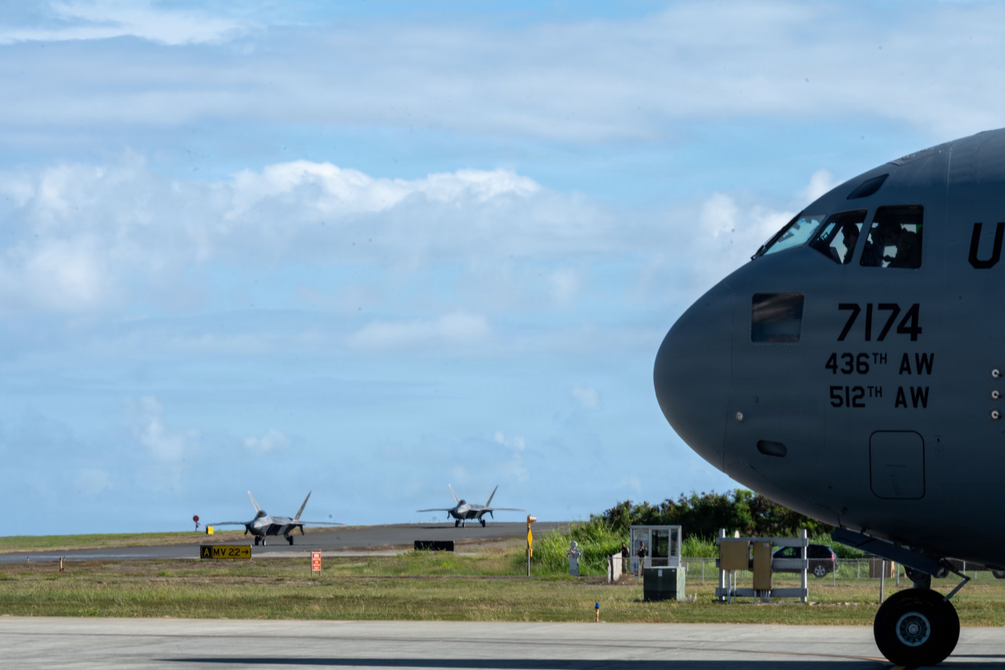Two F-22 Raptor aircraft from the Hawaiian Raptors taxi next to a C-17 Globemaster III during an Integrated Combat Turn in support of exercise Joint Pacific Multinational Readiness Center 26-1 at Marine Corps Base Hawaii, Hawaii, Nov. 6, 2025. Exercise JPMRC 26-01 is a large-scale joint and multinational exercise designed to train units and leaders in the region’s complex and austere jungle, arctic, and archipelago environments, replicating real-world conditions. JPMRC is a key way the Army contributes to Integrated Deterrence and regional security in the Indo-Pacific, training thousands of combat credible forces in the region.