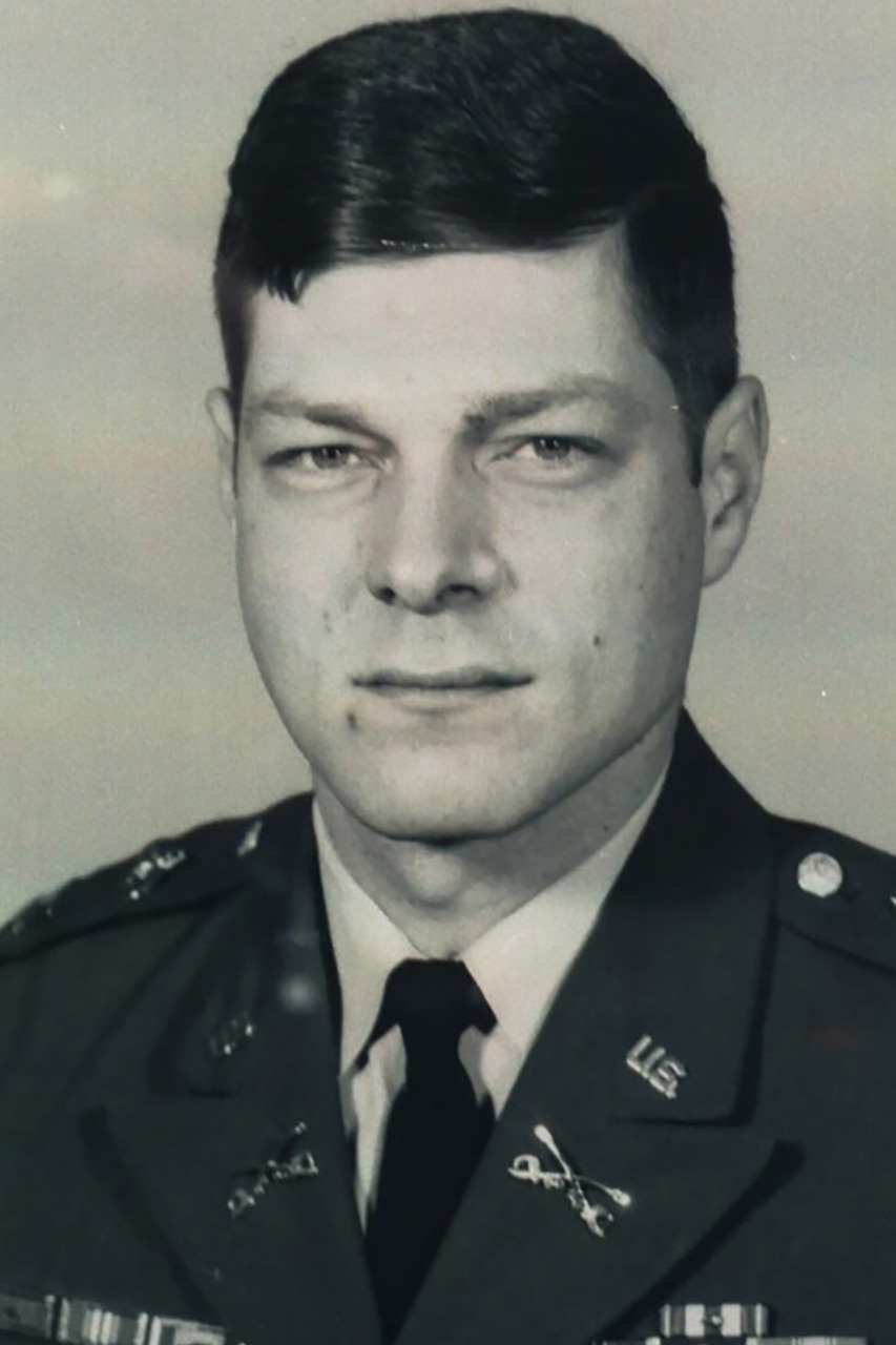 A man in uniform poses for a photo.