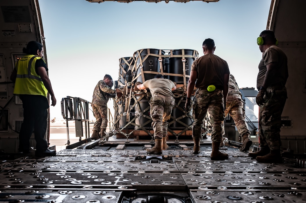 U.S. Air Force Airmen assigned to the 56th Fighter Wing and the 161st Logistics Readiness Squadron, move munitions cargo off a Boeing 747 during a Special Assignment Airlift Mission