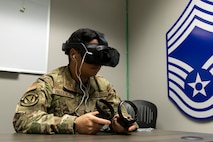 U.S. Air Force Airman Jeremy Prudencio, 13th Intelligence Squadron cryptologic analyst and reporter, uses virtual reality (VR) headgear installed with Moth+Flame programming while taking a professional development course at Recce-U, December 12, 2025, at Beale Air Force Base, California.