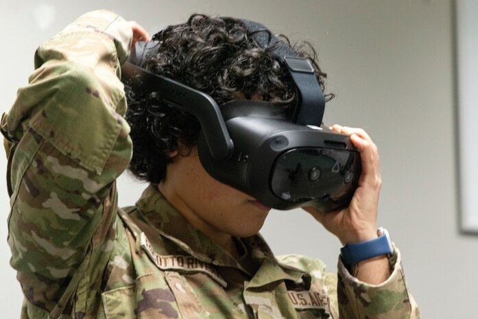 U.S. Air Force Airman Valerie Escotto-Rivera, 13th Intelligence Squadron signal intelligence analyst, puts on virtual reality (VR) headgear installed with Moth+Flame programming while taking a professional development course at Recce-U, December 12, 2025, at Beale Air Force Base, California.