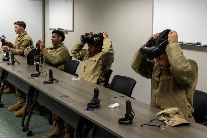 U.S. Air Force Airmen taking a professional development course at Recce-U use virtual reality (VR) headgear installed with Moth+Flame programming December 12, 2025, at Beale Air Force Base, California.