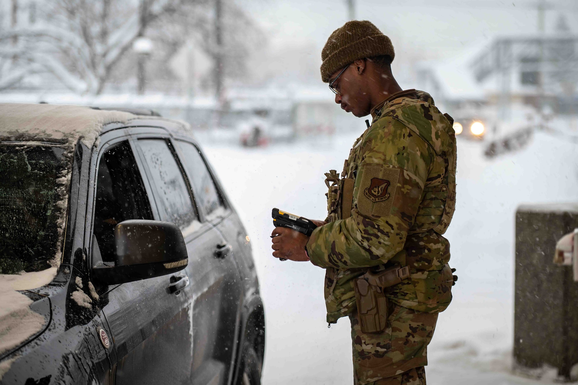 Airman Zaire Casner, a 673d Security Forces Squadron defender, scans ID cards at Joint Base Elmendorf-Richardson, Alaska, Jan. 6, 2026. Gate security operations protect the installation’s ability to generate combat power by preventing unauthorized access to mission-critical areas. (U.S. Air Force photo by Senior Airman Hunter Hites)