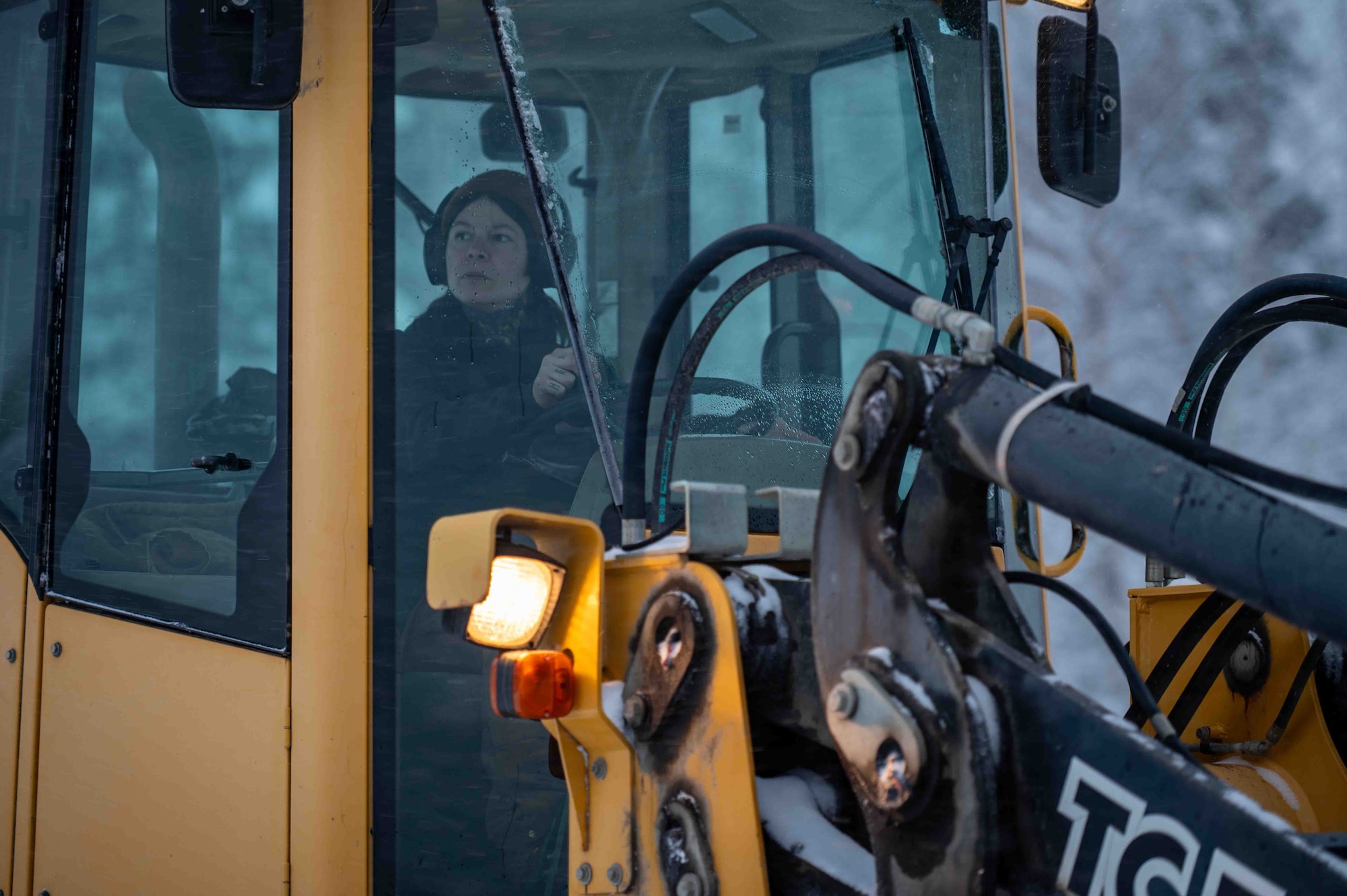Sam Brown, a 773d Logistics Readiness Squadron roads and grounds specialist, operates snow-clearing equipment to plow roads at Joint Base Elmendorf-Richardson, Alaska, Jan. 6, 2026. Clearing roads during severe weather reduces accident risk and preserves access to emergency services and essential infrastructure. (U.S. Air Force photo by Senior Airman Hunter Hites)