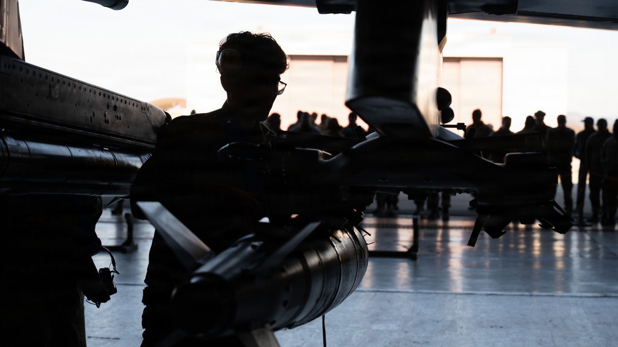 Spectators observe a member of the 35th Fighter Generation Squadron load an AIM-9X onto an F-16 Fighting Falcon during the 4th Quarter Ammo Bomb Building and Loading Competition at Osan Air Base, Republic of Korea, Jan. 8, 2026
