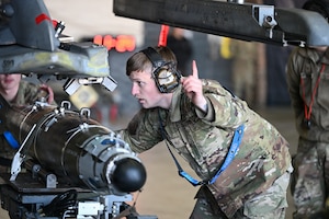 Members assigned to the 35th Fighter Generation Squadron load an AIM-9X onto an F-16 Fighting Falcon during the 4th Quarter Ammo Bomb Build and Loading Competition at Osan Air Base, Republic of Korea, Jan. 8, 2026.