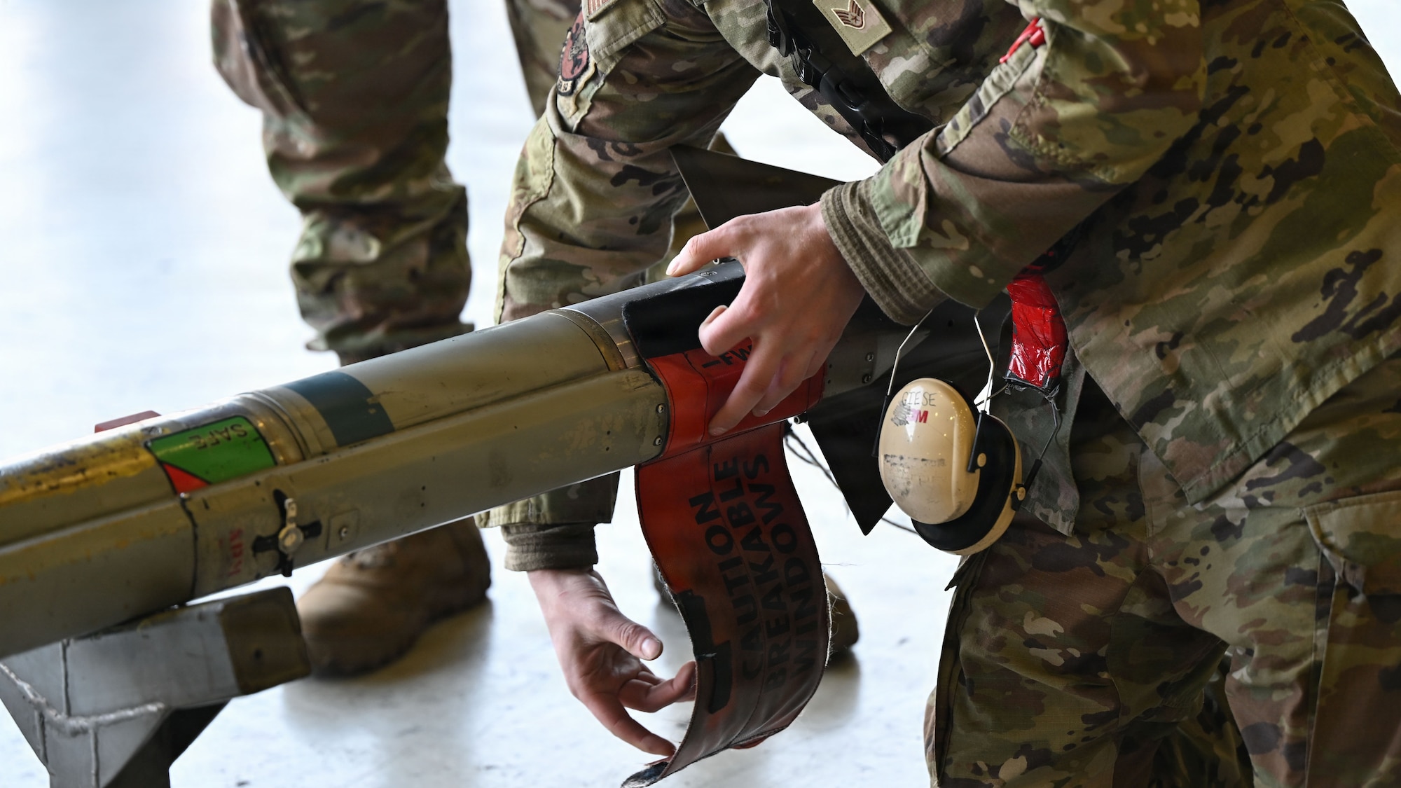 A member assigned to the 36th Fighter Generation Squadron handles an AIM-9X before loading it onto an F-16 Fighting Falcon during the 4th Quarter Ammo Bomb Build and Loading Competition at Osan Air Base, Republic of Korea, Jan. 8, 2026.