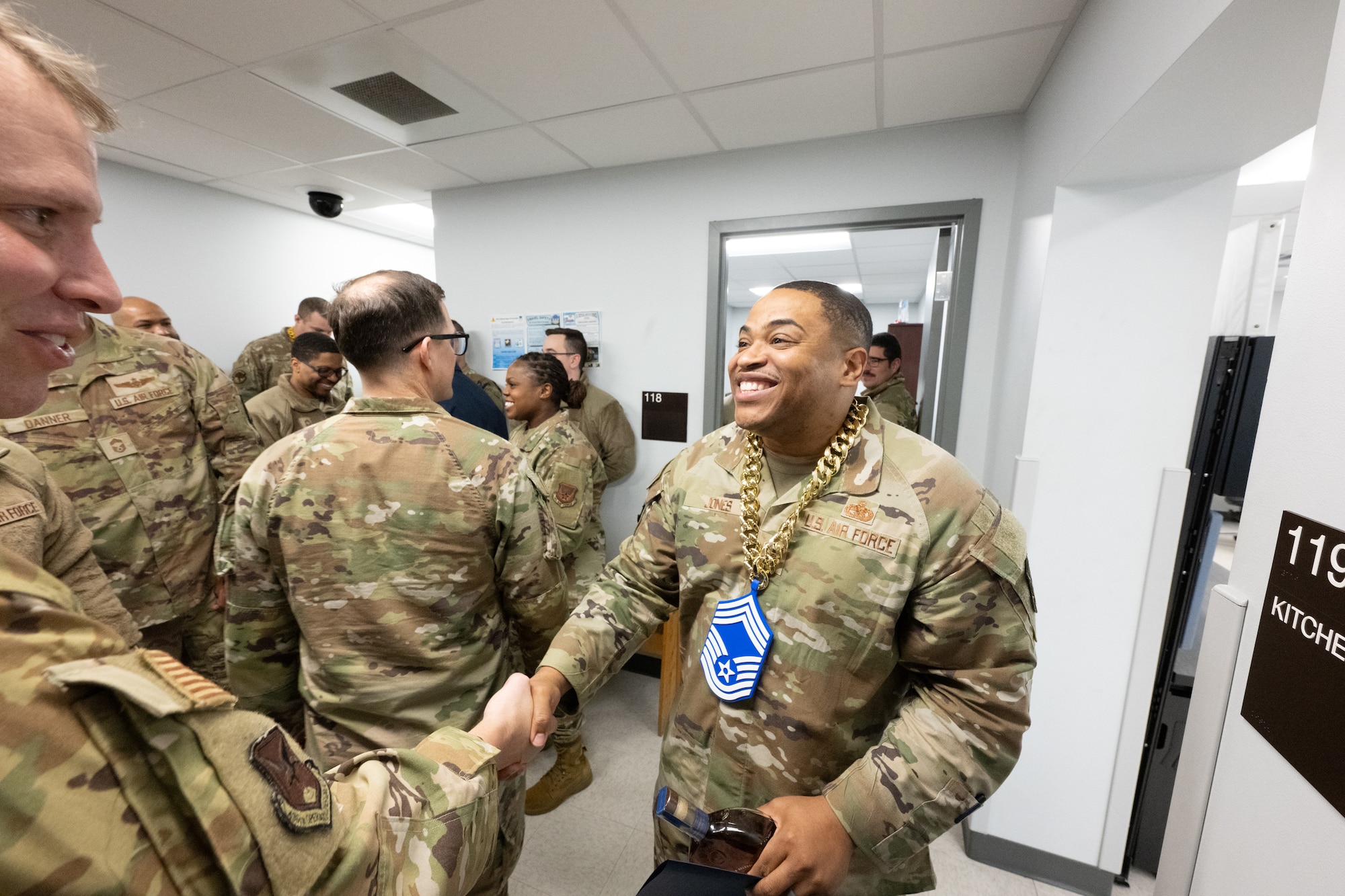 U.S. Air Force Senior Master Sgt. Terrance Jones, 436th Logistics Readiness Squadron fuels superintendent, is congratulated by friends and coworkers after being notified of his selection for promotion to the rank of Chief Master Sgt. at Dover Air Force Base, Delaware, Jan. 6, 2026. Traditionally, the Dover Chiefs’ Council gathers a selectee’s leadership and coworkers to surprise them with the news. (U.S. Air Force photo by Mauricio Campino)